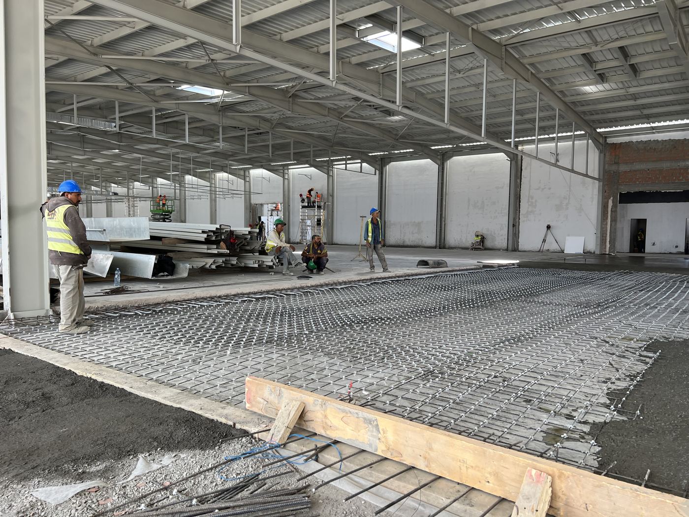 Reinforcing mesh in place on an industrial floor slab